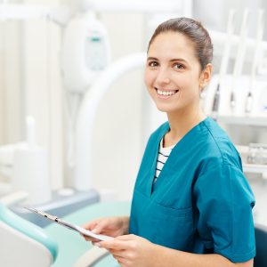 Dental Hygienist sitting in operatory posing